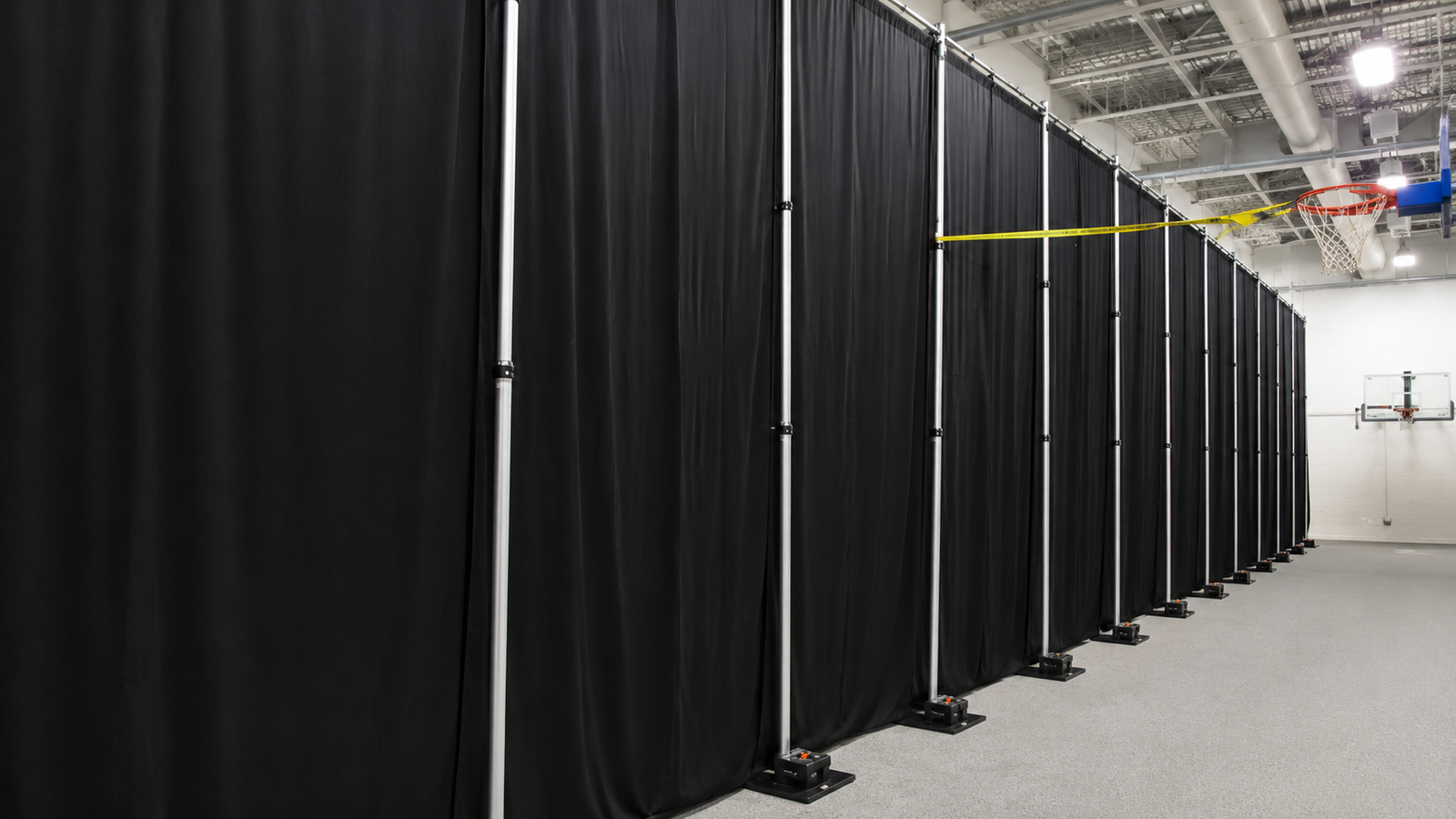 Pipe & base uprights supporting black drapes